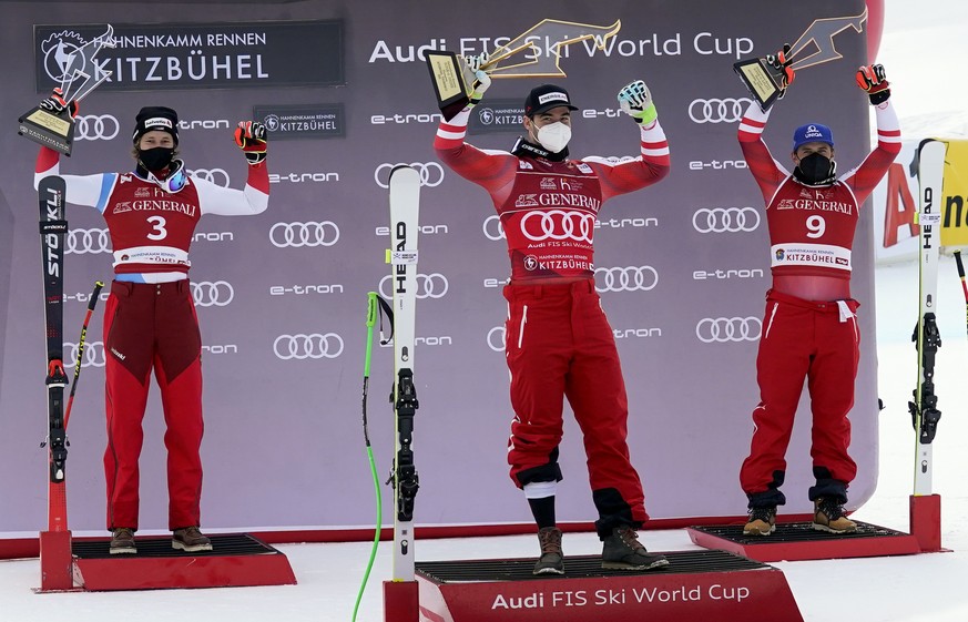Austria&#039;s Vincent Kriechmayr, center, winner of an alpine ski, men&#039;s World Cup Super-G, celebrates on the podium with second-placed Switzerland&#039;s Marco Odermatt, left, and third-placed  ...