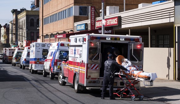 epa08337755 Paramedics transport a patient to the emergency room entrance of the Wyckoff Heights Medical Center in Brooklyn, New York, USA, 01 April 2020. New York City is still the epicenter of the c ...