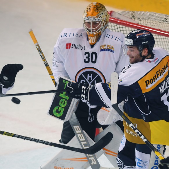 Lugano&#039;s player Thomas Wellinger, Lugano&#039;s goalkeeper Elvis Merzlikins, Ambri&#039;s player Marco Mueller, from left, during the regular season game of the National League Swiss Championship ...