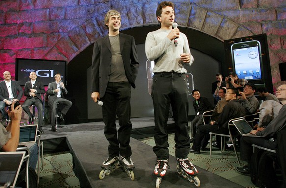 In this photo provided by HTC, Google founders Larry Page, left, and Sergey Brin, help introduce the new T-Mobile G1 phone by Google, which is manufactured by Taiwan-based HTC, Tuesday, Sept., 23, 200 ...