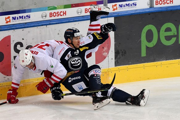 Ambri&#039;s player Scottie Upshall right fights for the puck with Lausanne&#039;s player Joel Genazzi left, during the preliminary round game of National League A (NLA) Swiss Championship 2019/20 bet ...