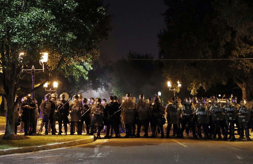 Police line up as protesters gather, Friday, Sept. 15, 2017, in St. Louis, after a judge found a white former St. Louis police officer, Jason Stockley, not guilty of first-degree murder in the death o ...