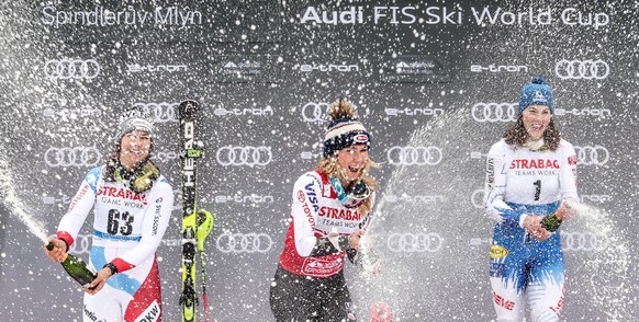 epa07424566 (L-R) Second placed Wendy Holdener of Switzerland, first placed Mikaela Shiffrin of US and third placed Petra Vlhova of Slovakia celebrate on the podium during trophy ceremony of Women&#03 ...