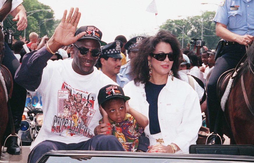 Chicago Bulls&#039; Michael Jordan, left, waves to the crowd as he arrives for a Bulls victory rally with his wife, Juanita, right,and son Jeffrey, in Grant Park in Chicago, June 14, 1991. On Friday,  ...