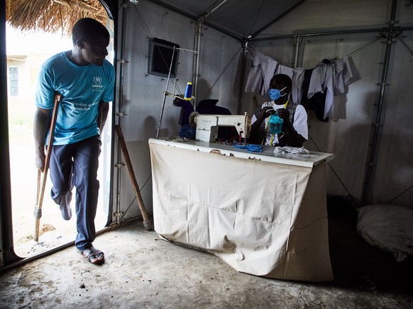 epa08891337 (28/39) Refugees sew face masks at a UNHCR program to prevent the transmission of Covid-19, at the Biringi refugee settlement, Aru Territory, Ituri Province, Democratic Republic of Congo,  ...