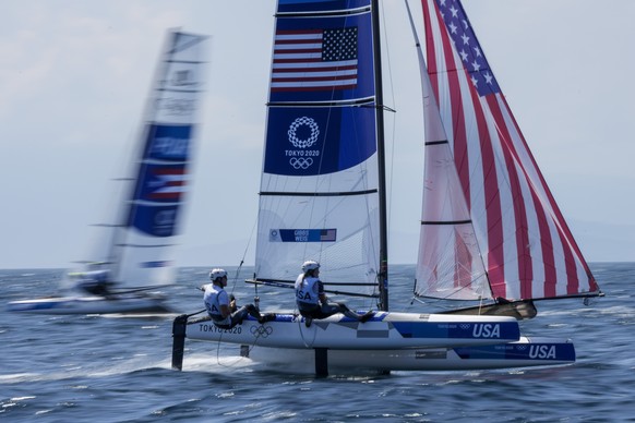 Anna Weis and Riley Gibbs, from US, compete during the Nacra race at the Enoshima harbour during the 2020 Summer Olympics, Sunday, Aug. 1, 2021, in Fujisawa, Japan. (AP Photo/Bernat Armangue)