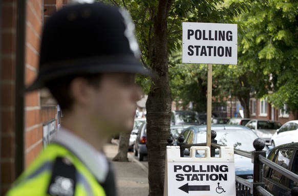 A police officer stands outside a polling station in Tower Hamlets, east London May 22, 2014. Police were stationed outside some polling stations on Thursday in an attempt to prevent election fraud. R ...