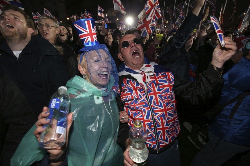 Brexit supporters celebrate during a rally in Parliament square in London, England as Britain left the European Union on Friday, Jan. 31, 2020. Britain officially leaves the European Union on Friday a ...