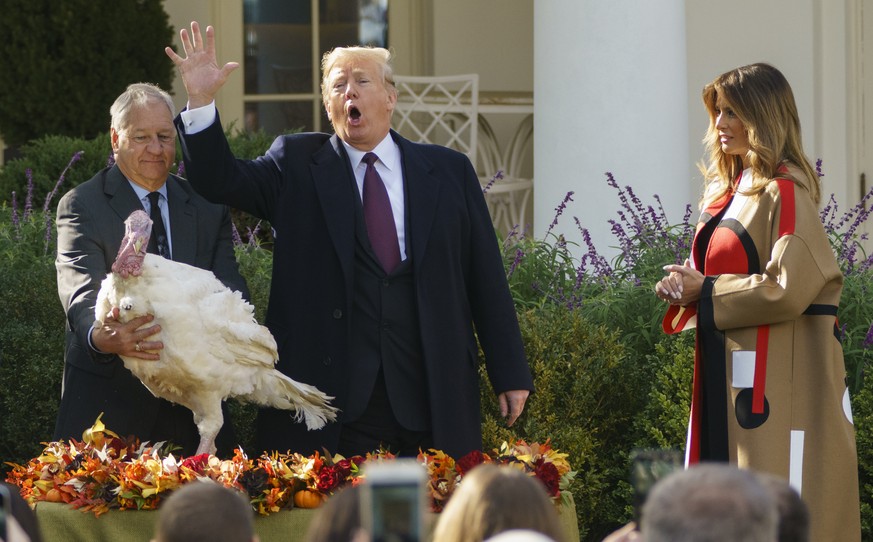 President Donald Trump pardons &quot;Peas&quot;, as he and first lady Melania Trump participate in a ceremony to pardon the National Thanksgiving Turkey in the Rose Garden of the White House in Washin ...