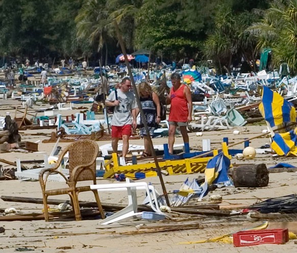 European tourists walk the beach of Kata assessing damages done by the tidal wave that hit Kata beach in Phuket, Thailand, Sunday, December 26, 2004. One of the most-powerful earthquakes in years trig ...