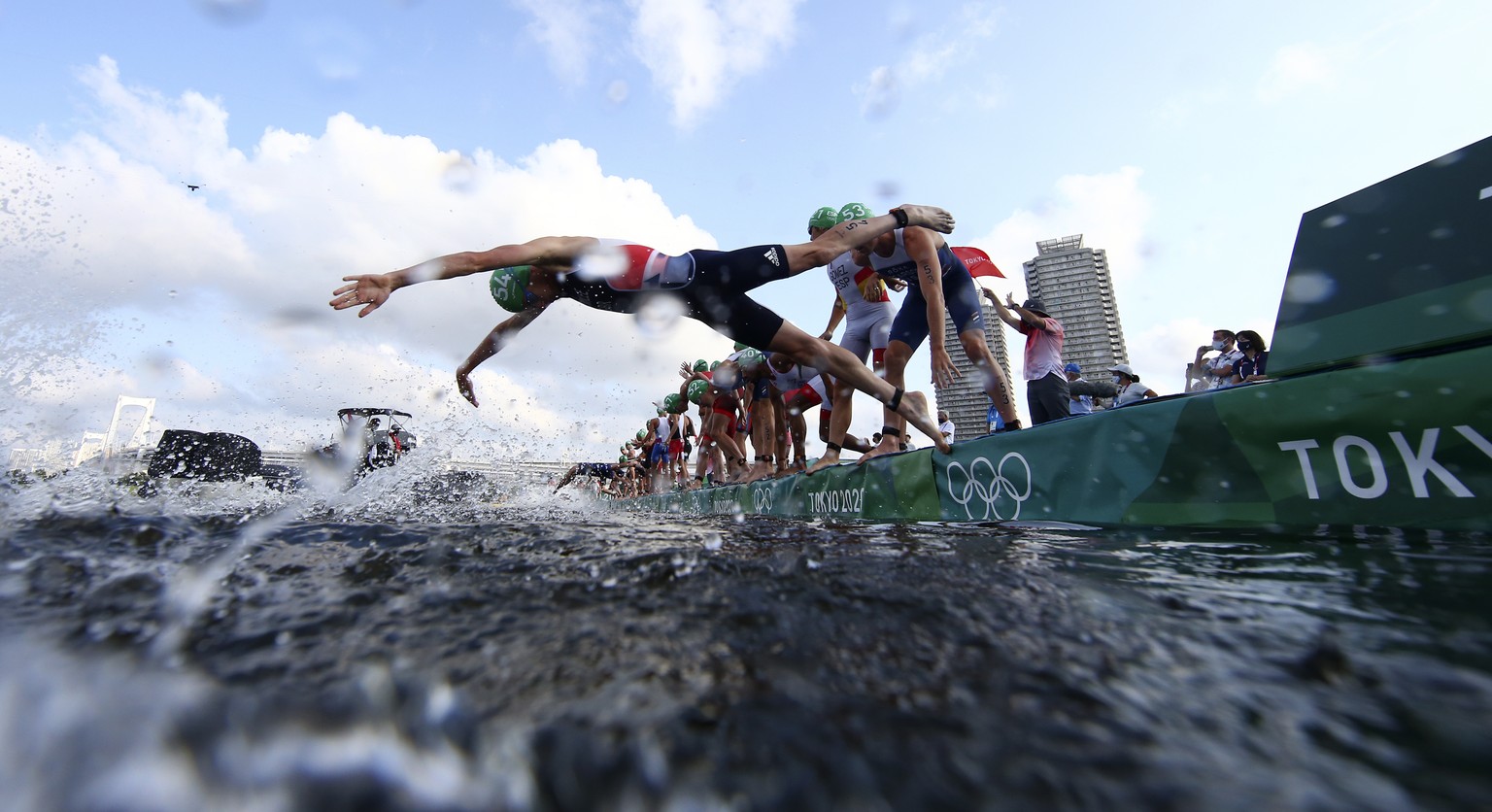 Jonathan Brownlee, of Britain, jumps in to compete in the swim leg of the men&#039;s individual triathlon at the 2020 Summer Olympics, Monday, July 26, 2021, in Tokyo. (Antonio Bronic/Pool Photo via A ...