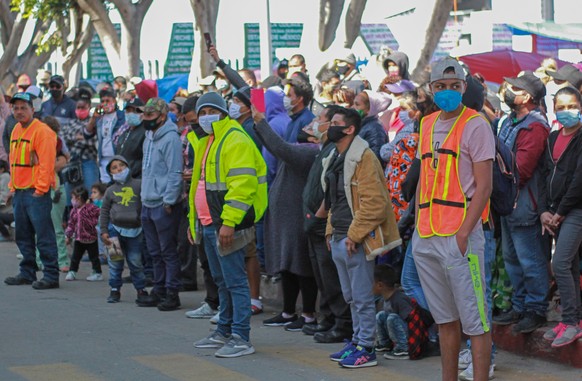 epa09080894 A group of migrants protests in a camp set up near the border port of Chaparral, in the border city of Tijuana, Mexico, 17 March 2021. Tension, despair and uncertainty are perceived along  ...