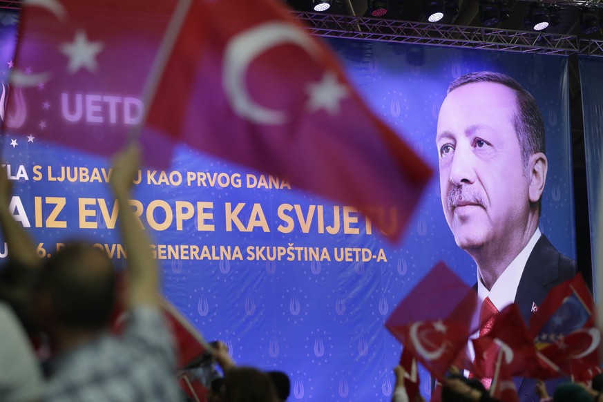 People wave Turkish and Bosnian flags in front of an image of Turkey&#039;s president Recep Tayyip Erdogan displayed during a rally, in Sarajevo, Bosnia, on Sunday, May 20, 2018. Turkey&#039;s preside ...