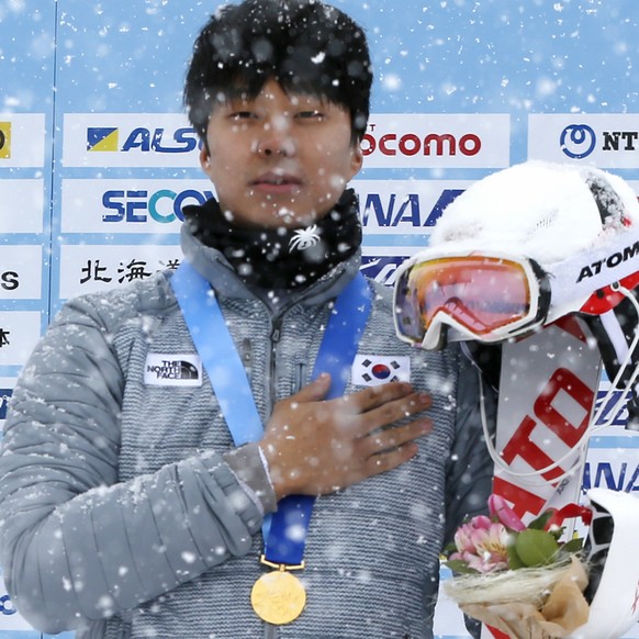 South Korea&#039;s gold medalist Jung Dong-hyun listens to the national anthem during a awarding ceremony of the alpine skiing men&#039;s slalom at the Asian Winter Games in Sapporo, northern Japan, S ...