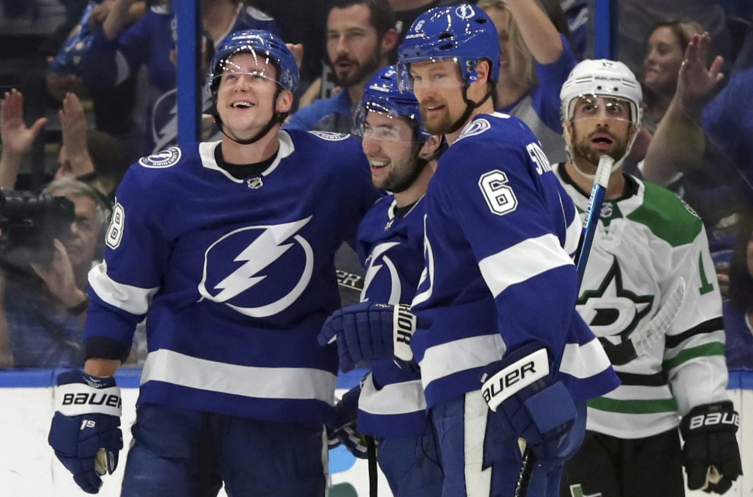 Tampa Bay Lightning&#039;s Ondrej Palat, of the Czech Republic, Tyler Johnson, and Anton Stralman, of Sweden, celebrate a goal as Dallas Stars&#039; Andrew Cogliano reacts during the first period of a ...