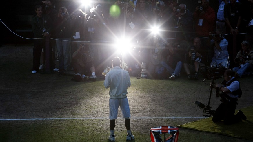 Spain&#039;s Rafael Nadal poses for photographers with his trophy after his win over Switzerland&#039;s Roger Federer in the men&#039;s singles final on the Centre Court at Wimbledon, Sunday, July 6,  ...