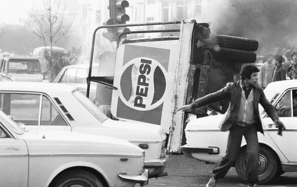 In this Dec. 27, 1978 picture, an overturned truck with a Pepsi soft drink logo burns in the center of Tehran during riots which paralyzed the city. The popular revolt against the shah raised alarm be ...