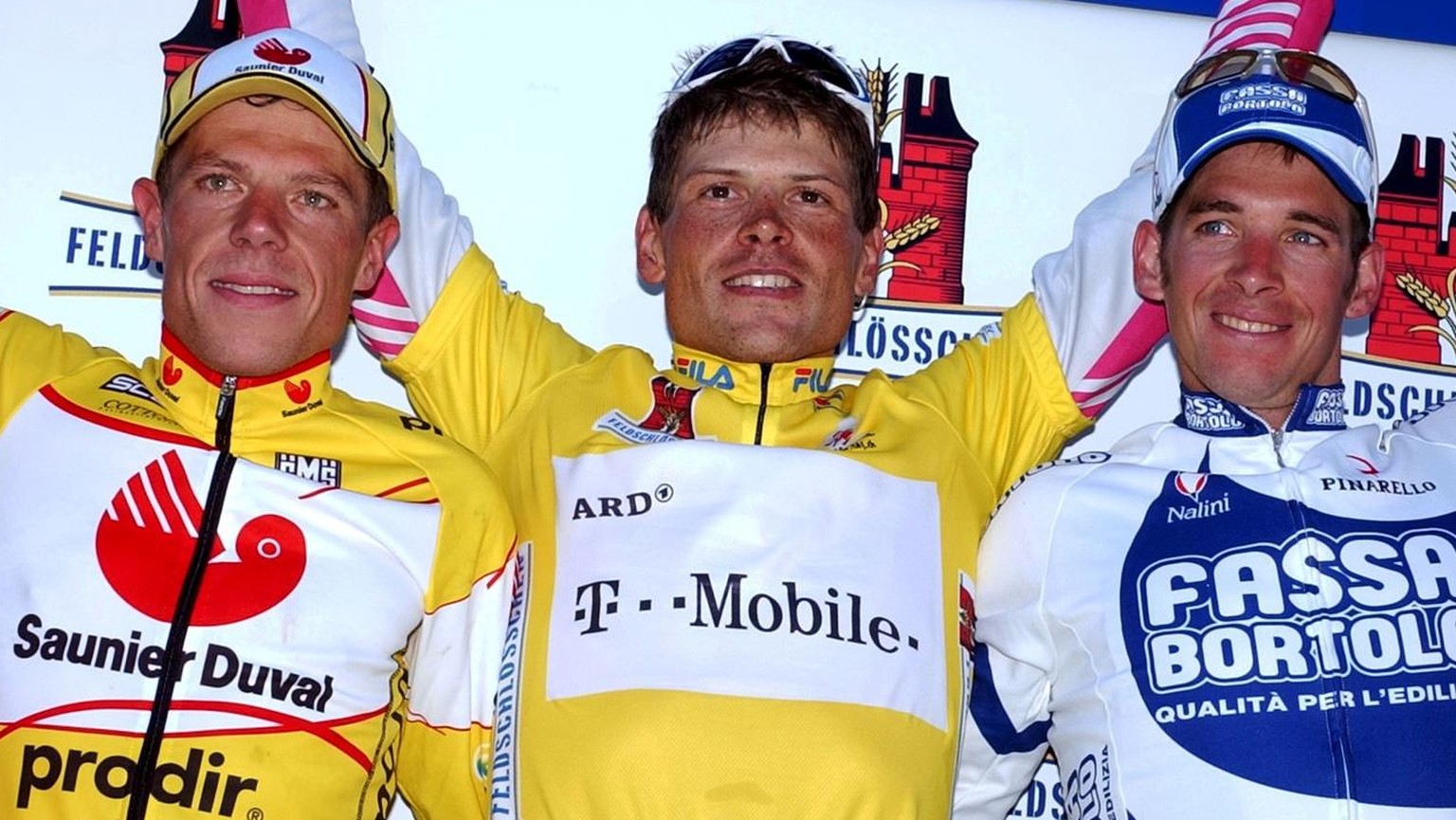German Jan Ullrich, centre, overall winner of the Tour de Suisse cycling race, Swiss Fabian Jeker, left, second in the overall ranking and Dario David Cioni, from Italy, right, third in the overall ra ...