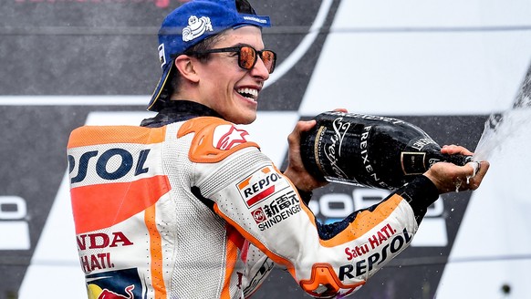 epa06061683 Spanish MotoGP rider Marc Marquez of the Repsol Honda Team celebrates on the podium after winning the MotoGP race of the motorcycling Grand Prix of Germany at the Sachsenring racing circui ...