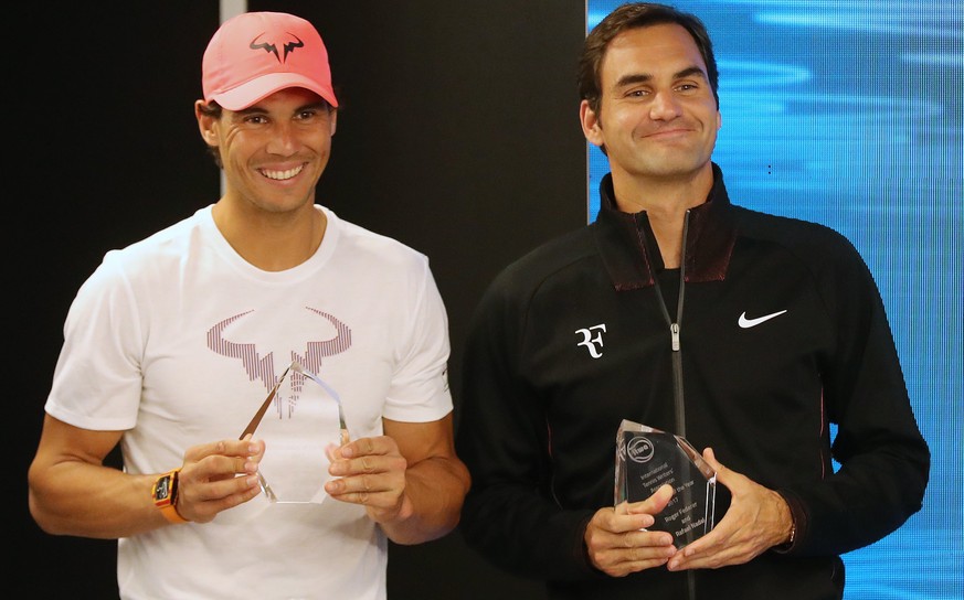epa06434687 Rafael Nadal (L) of Spain and Roger Federer (R) of Switzerland hold their trophies for the International tennis Writers Association &#039;Ambassadors of the Year&#039; awards during a pres ...