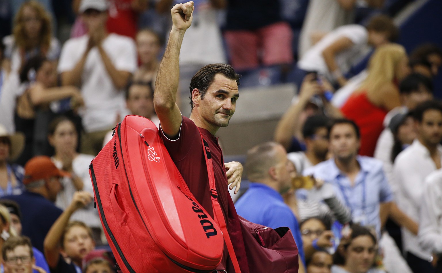 Roger Federer, of Switzerland, waves to the crowd as he leaves the court after losing to John Millman, of Australia, during the fourth round of the U.S. Open tennis tournament early Tuesday, Sept. 4,  ...