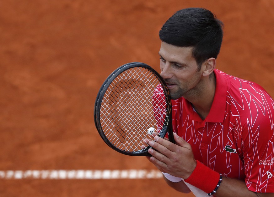 In this Friday, June 12, 2020 photo, Serbia&#039;s Novak Djokovic reacts during a tennis doubles match with Jelena Jankovic against Serbia&#039;s Nenad Zimonjic and Olga Danilovic at charity tournamen ...