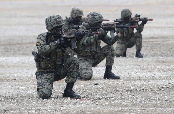 South Korean army soldiers aim their machine guns during a defense expo, DX Korea 2020, in Goyang, South Korea, Wednesday, Nov. 18, 2020. (AP Photo/Ahn Young-joon)