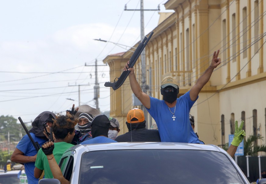 Heavily armed pro-government militia flash victory signs as they occupy the Monimbo neighborhood of Masaya, Nicaragua, Wednesday, July 18, 2018. On Tuesday, Nicaraguan government forces retook the sym ...