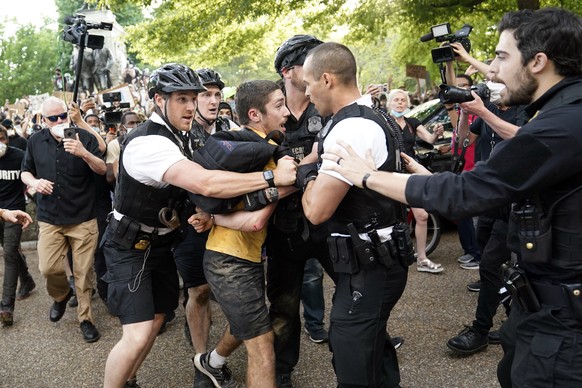 Uniformed U.S. Secret Service police detain a protester in Lafayette Park across from the White House as demonstrators protest the death of George Floyd, a black man who died in police custody in Minn ...