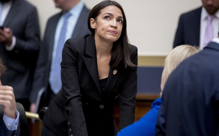 Rep. Alexandria Ocasio-Cortez, D-N.Y., appears before Facebook CEO Mark Zuckerberg arrives for a House Financial Services Committee hearing on Capitol Hill in Washington, Wednesday, Oct. 23, 2019, on  ...