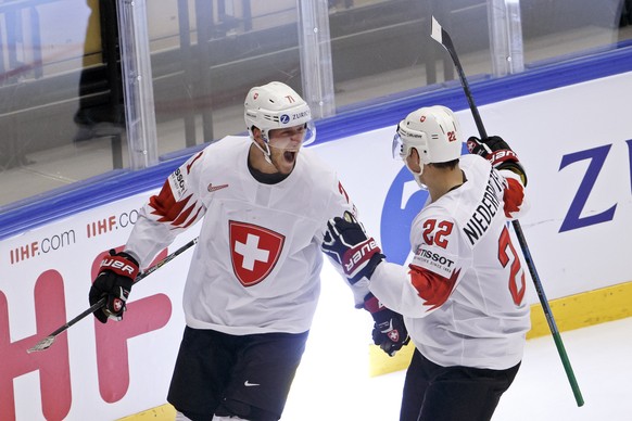 Switzerland&#039;s forward Enzo Corvi, left, celebrates his gaol with teammate forward Nino Niederreiter, right, after scoring the 1:1, during the IIHF 2018 World Championship quarter final game betwe ...