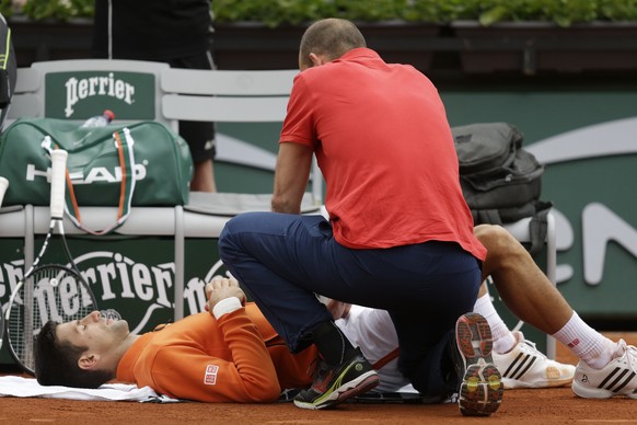 Serbia&#039;s Novak Djokovic is treated for injury in the second round match of the French Open tennis tournament against Luxembourg&#039;s Gilles Muller at the Roland Garros stadium, in Paris, France ...