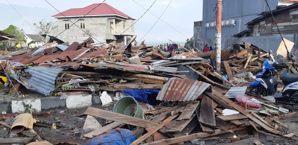 epa07055698 A handout photo made available by the Indonesian National Board for Disaster Management (BNPB) shows houses in ruins after a 7.7 magnitude earthquake in Palu, Central Sulawesi, Indonesia,  ...