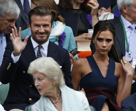 David and Victoria Beckham take their seats in the Royal Box prior to the men’s singles final between Roger Federer of Switzerland and Novak Djokovic of Serbia on centre court at the All England Lawn  ...