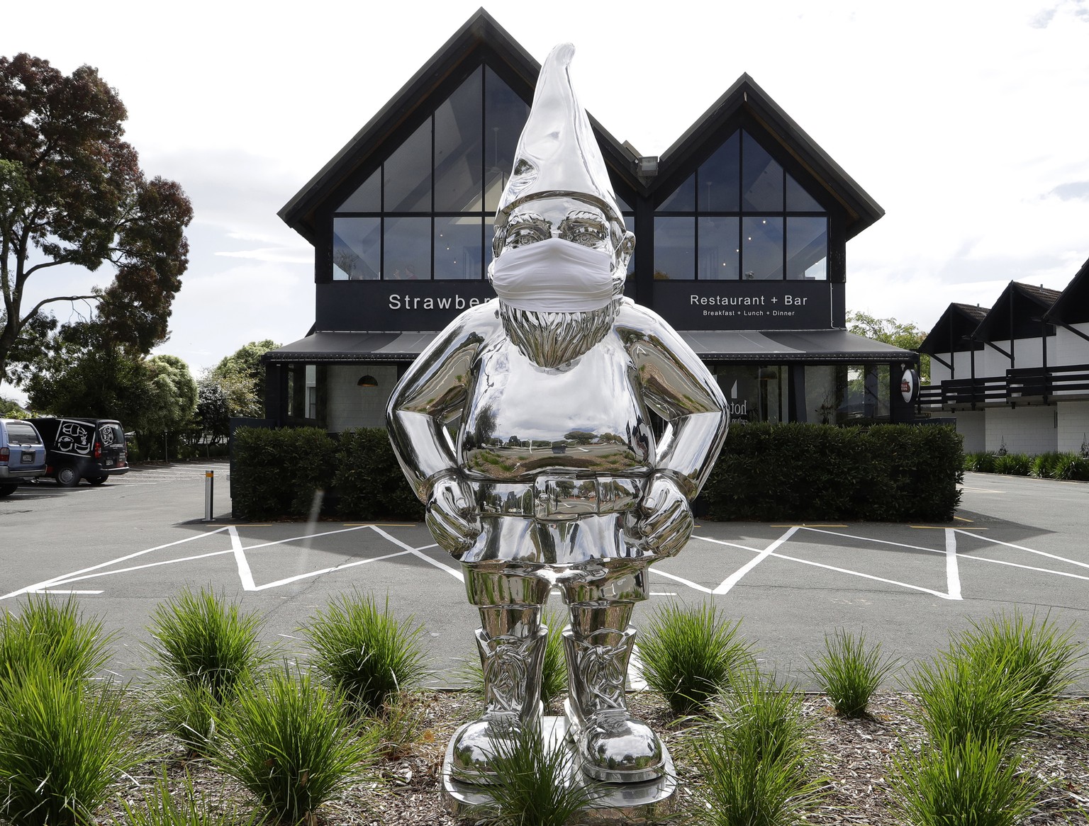 A statue outside a restaurant wears a mask in central Christchurch, New Zealand, Monday, March 23, 2020. New Zealand Prime Minister Jacinda Ardern announced Monday that schools and non-essential servi ...