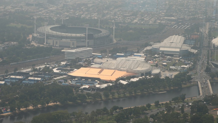 epa08129049 A view of the Australian Tennis centre and MCG from Eureka Tower as smoke and haze from bushfires continues to hang over Melbourne, Australia, 15 January 2020. EPA/DAVID CROSLING AUSTRALIA ...