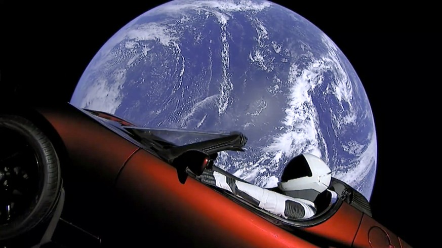 This image from video provided by SpaceX shows the company&#039;s spacesuit in Elon Musk&#039;s red Tesla sports car which was launched into space during the first test flight of the Falcon Heavy rock ...