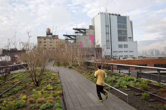 In this Tuesday, April 21, 2015 photo, a runner on New York&#039;s High Line runs toward the Whitney Museum of American Art, right. The Whitney opens the doors to its new home on May 1. It’s an asymme ...