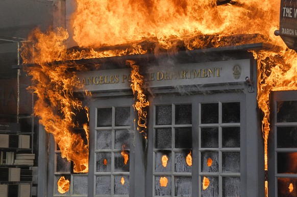 A Los Angeles Police Department kiosk is seen ablaze in The Grove shopping center during a protest over the death of George Floyd, Saturday, May 30, 2020, in Los Angeles. Protests were held in U.S. ci ...