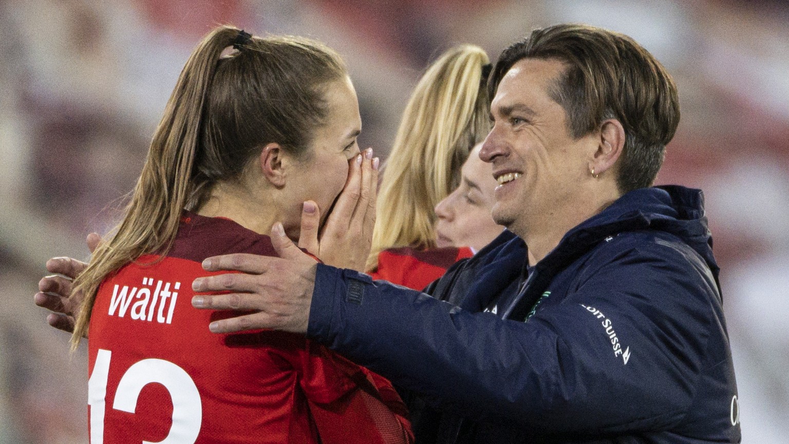 Swiss head coach Nielsen Nils, center, celebrates after with Lia Waelti, left, and Fabienne Humm, right, after winning the UEFA Women&#039;s Euro 2022 play-off 2nd leg qualification match between Swit ...