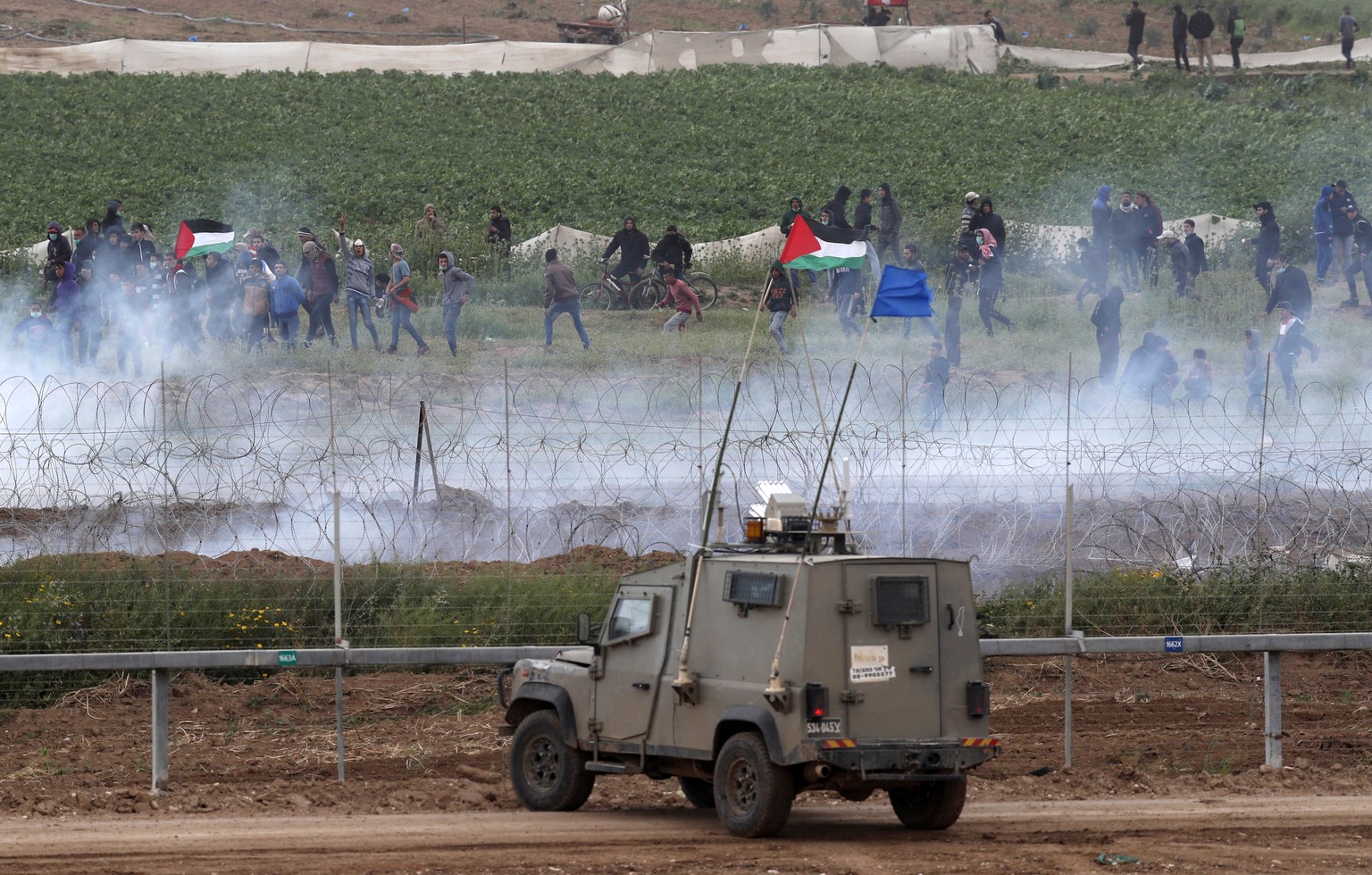 epa07473327 Clashes between Palestinian protesters from Gaza strip and Israeli soldiers as soldiers taking positions at the security fence next to Nahal Oz, facing the Gaza neighborhood of Shjaaia, 30 ...