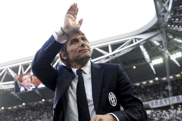 FILE - In this April 7, 2014 file photo, Juventus coach Antonio Conte waves to supporters during a Serie A soccer match between Juventus and Livorno at the Juventus stadium, in Turin, Italy. On Tuesda ...