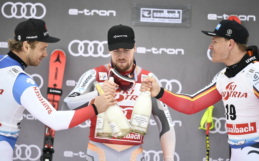 epa08217490 (L-R) Second placed Mauro Caviezel of Switzerland, winner Aleksander Aamodt Kilde of Norway and third placed Thomas Dressen of Germany celebrate on the podium of the men&#039;s Super-G rac ...