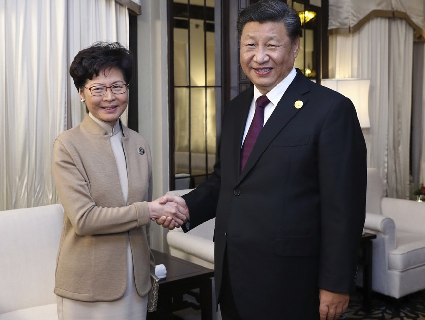 In this Monday, Nov. 4, 2019, file photo released by China&#039;s Xinhua News Agency, Chinese President Xi Jinping poses with Hong Kong Chief Executive Carrie Lam for a photo during a meeting in Shang ...