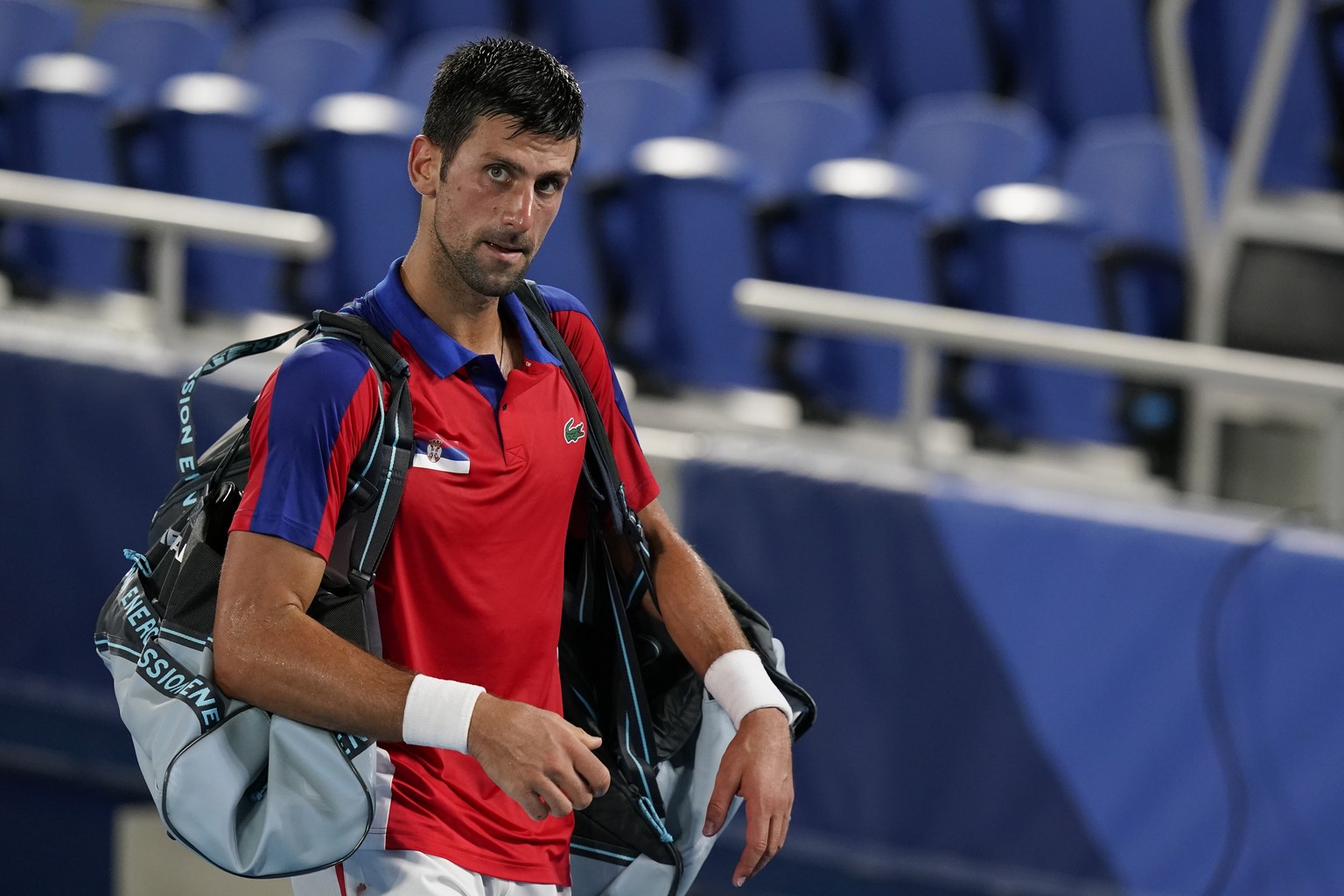 Novak Djokovic, of Serbia, walks off the court after losing a semifinal men&#039;s tennis match to Alexander Zverev, of Germany, at the 2020 Summer Olympics, Friday, July 30, 2021, in Tokyo, Japan. (A ...