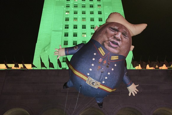 A Baby Trump Balloon floats outside City Hall in Los Angeles Tuesday, Dec. 17, 2019. President Donald Trump is on the cusp of being impeached by the House, with a historic debate set Wednesday on char ...