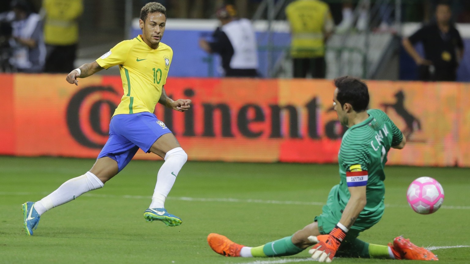 FILE - In this Tuesday, Oct. 10, 2017 filer, Brazil&#039;s Neymar kicks the ball past Chile goalkeeper Claudio Bravo, right, during a World Cup qualifying soccer match in Sao Paulo, Brazil. (AP Photo/ ...