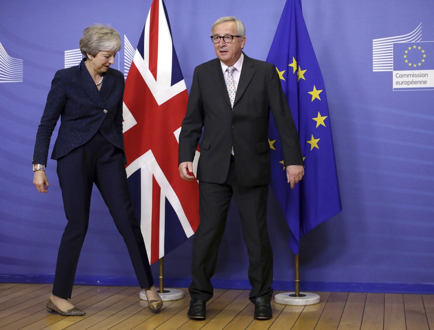 European Commission President Jean-Claude Juncker, right, greets British Prime Minister Theresa May prior to a meeting at EU headquarters in Brussels, Saturday, Nov. 24, 2018. British Prime Minister T ...