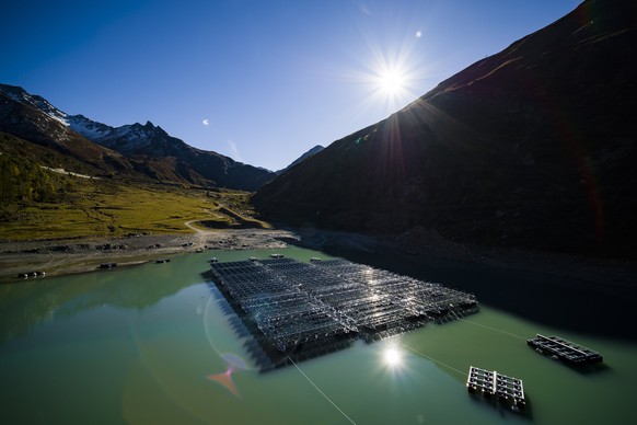 Floating barges with solar panels are pictured on the &#039;Lac des Toules&#039;, an alpine reservoir lake, in Bourg-Saint-Pierre, Switzerland, Tuesday, Oct. 8, 2019. After completion the floating sol ...