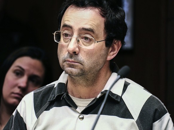 FILE - In this Feb. 17, 2017, file photo, Dr. Larry Nassar listens to testimony of a witness during a preliminary hearing, in Lansing, Mich. Olympic gymnast Aly Raisman says she is among the young wom ...